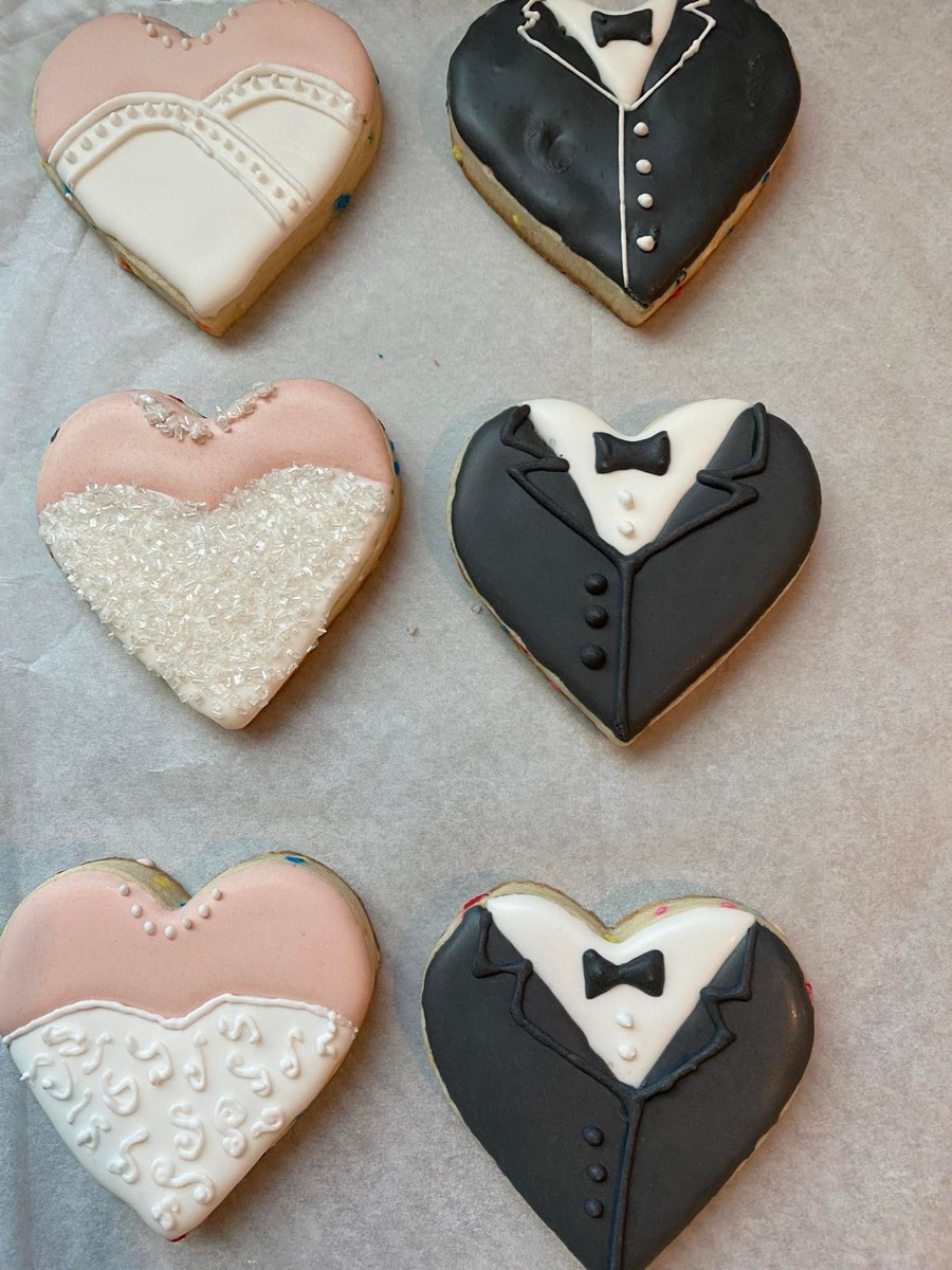 Wedding themed decorated sugar cookies with bride and groom heart designs